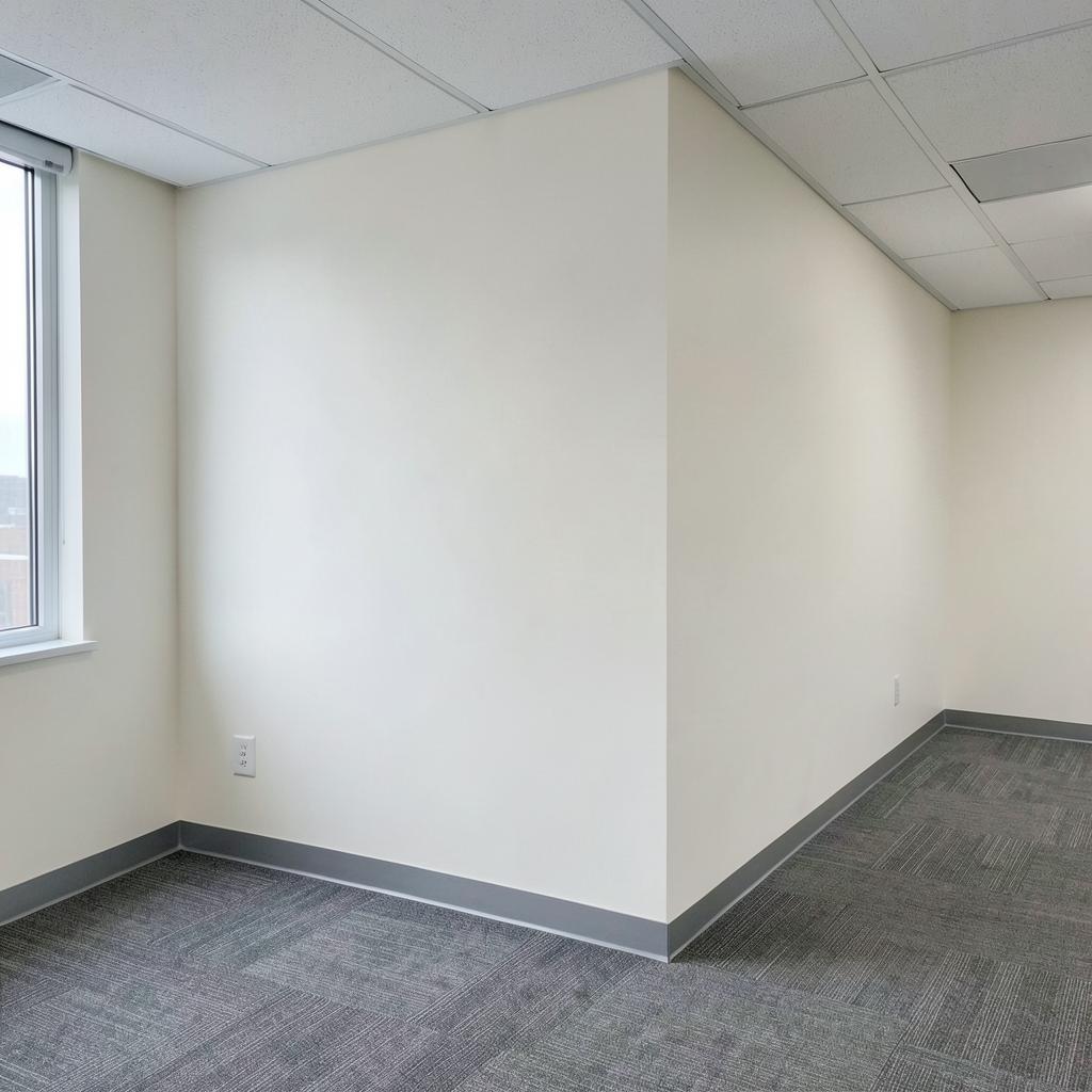 Smooth freshly painted office wall with clean corner after commercial drywall repair in Colorado Springs